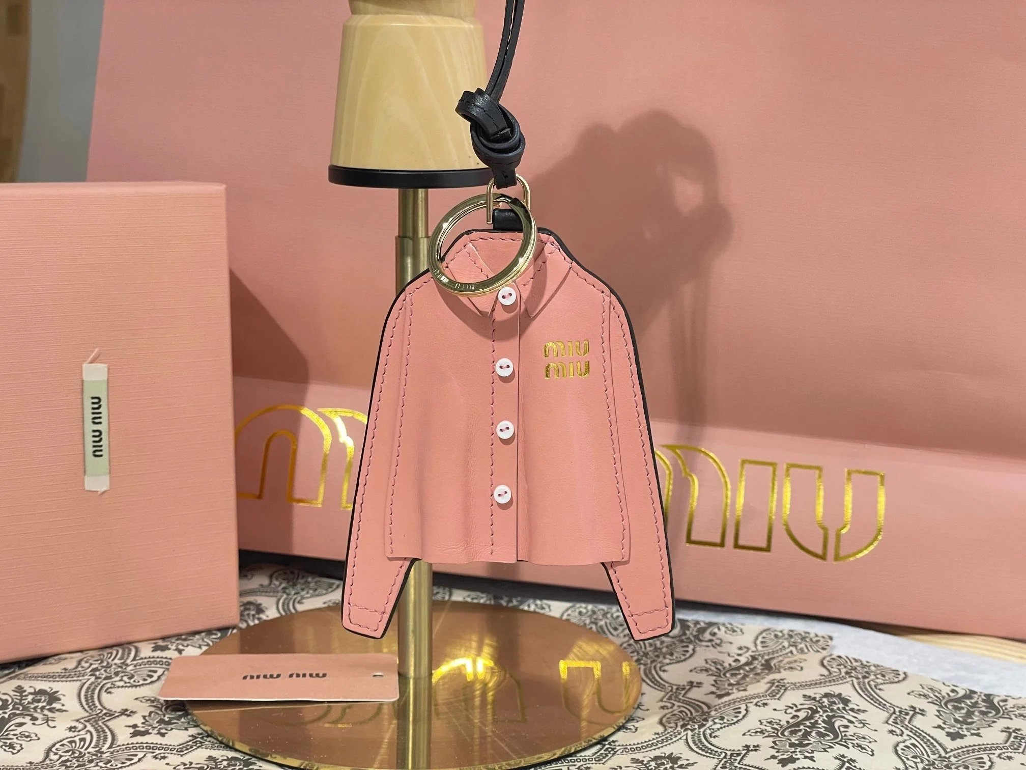 Pink Shirt-Shaped Charm with a Dark Loop and Reflective Back Detail