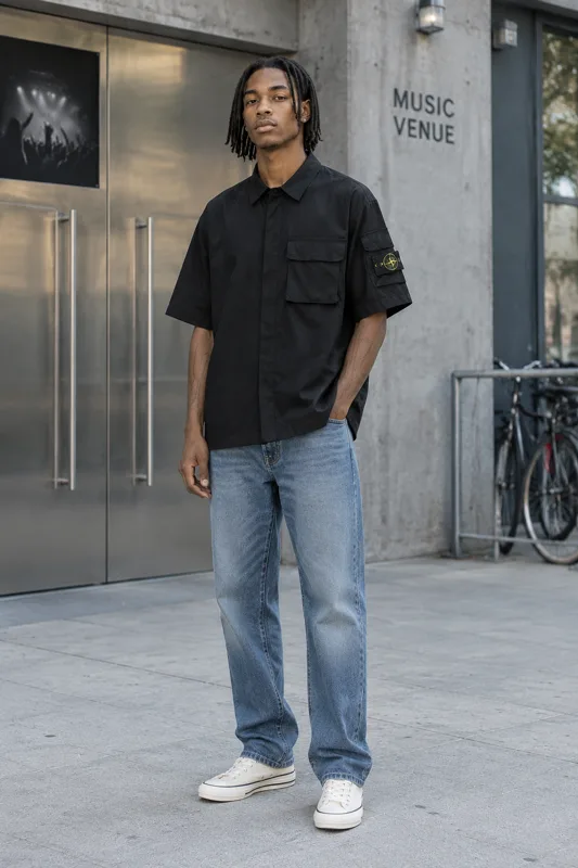 Black Short-Sleeve Utility Shirt and Faded Blue Jeans · Zion