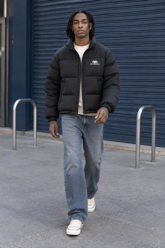 Black Puffer Jacket and Loose Blue Jeans Winter Look · Zion